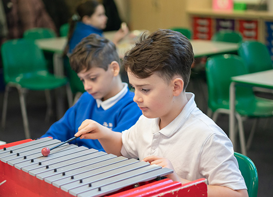 Students playing instruments in workshops