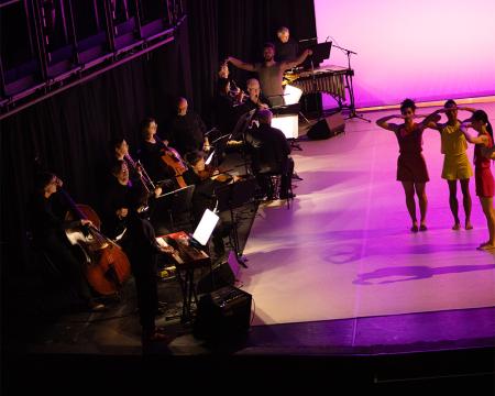 dancers meet musician with a purple colour wash