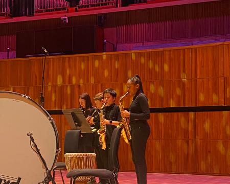 Students with Saxophones on stage