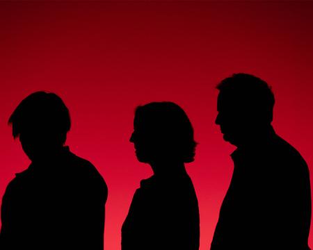musicians silhouettes bathed in red light 