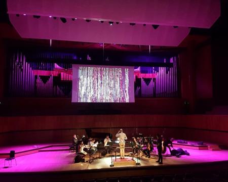 A wide shot of the Royal Festival Hall with London Sinfonietta musicians on stage
