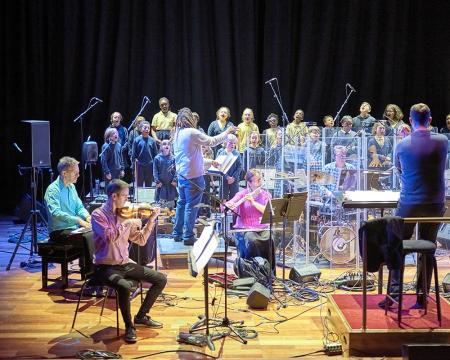 Wide shot of London Sinfonietta musicians and Belham Primary School performing at the Tapestries concert