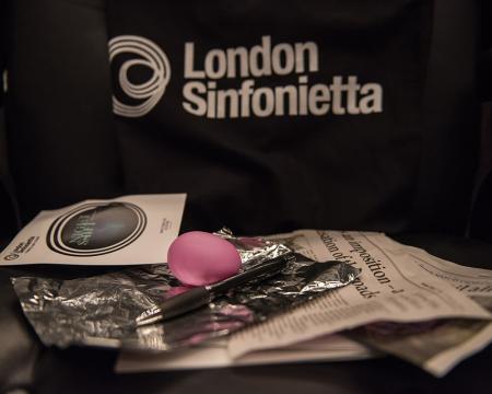 Various objects laid in front of a black London Sinfonietta bag