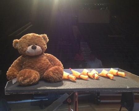 A teddy bear on a music stand