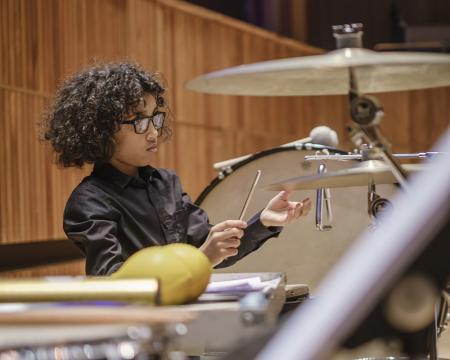 An image of a young male percussion player at a London Sinfonietta Schools Concert