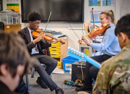 Laura Cooper playing strings with a student