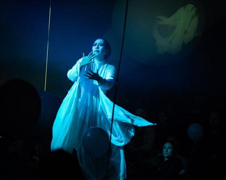 Dancer Chisato Minamimura standing in blue toned lights