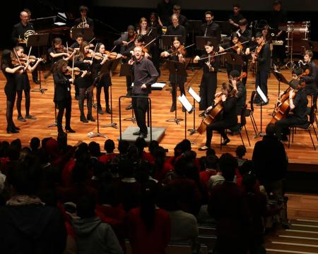 A wide shot of an orchestra and audience at a London Sinfonietta family concert