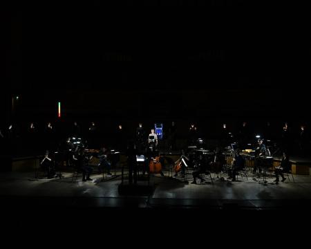 The London Sinfonietta and a row of cyclists on stage at the Royal Festival Hall