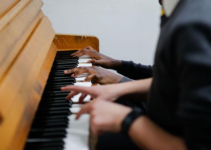 St ignatius students playing the piano - photo credit: Koice Media